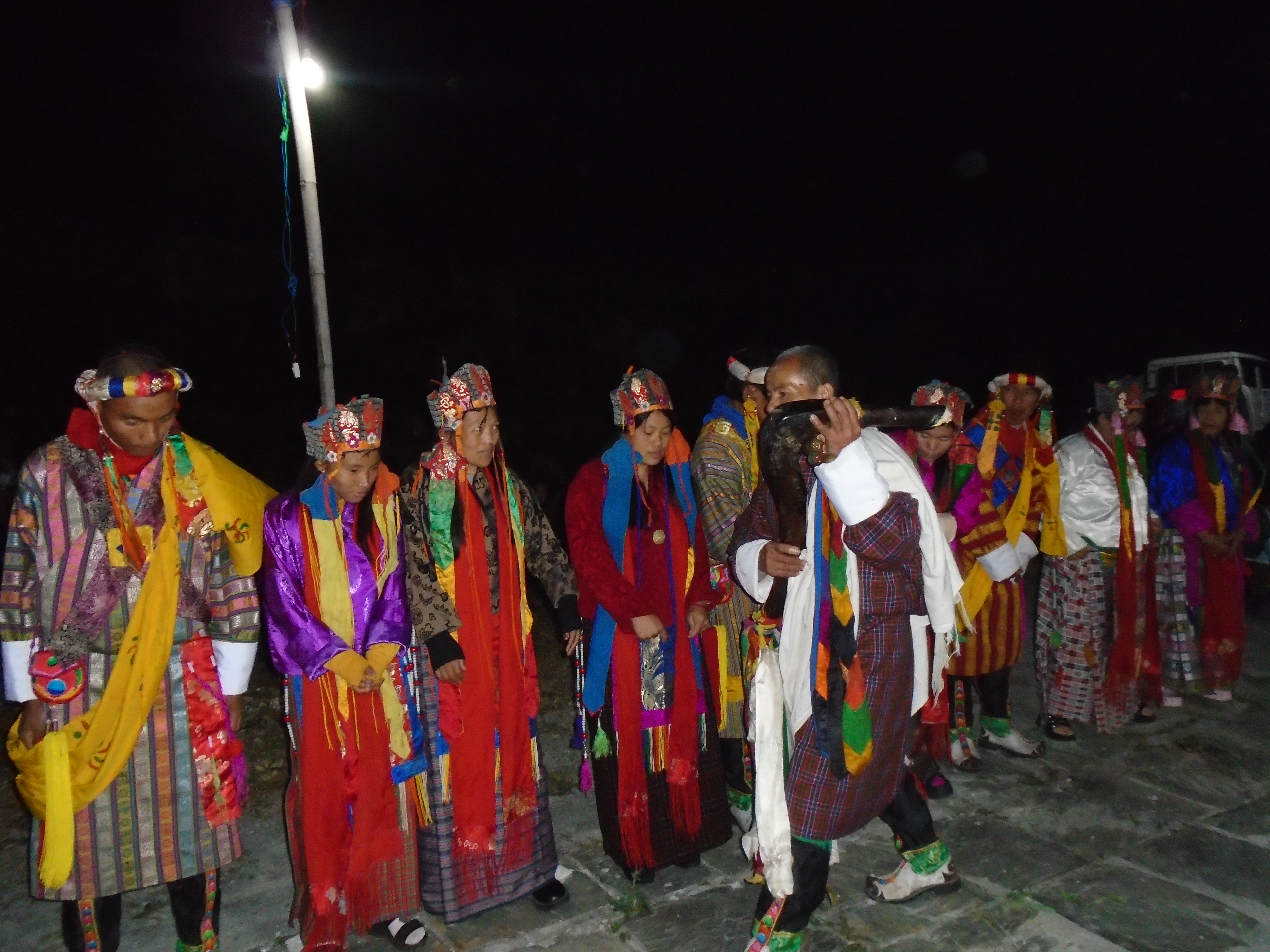 Bopa (male) and boma (female) dancers participating in the Kharphu festival in Daksa village, Mongar district, December 2025.