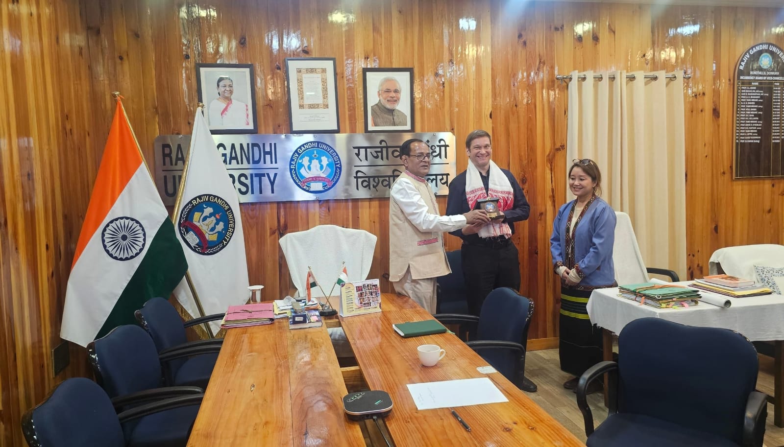 The Vice Chancellor-in-charge presenting a token of appreciation to Tim in the presence of Dr. Lisa Lomdak.